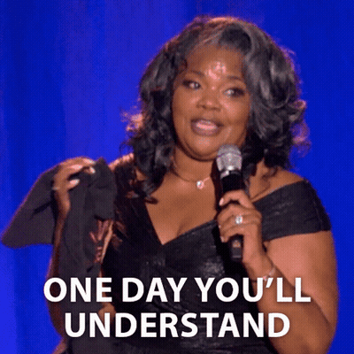 A Woman Holding A Microphone With The Words One Day You 'Ll Understand Below Her GIF