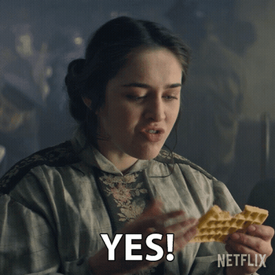 A Woman Holding A Piece Of Food With The Word Yes Written On It GIF