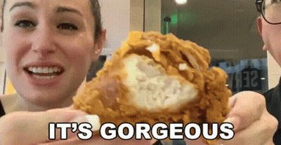 A Woman Holding A Piece Of Fried Chicken With The Words It 'S Gorgeous GIF