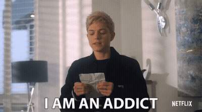 A Woman Holding A Piece Of Paper That Says I Am An Addict On It GIF