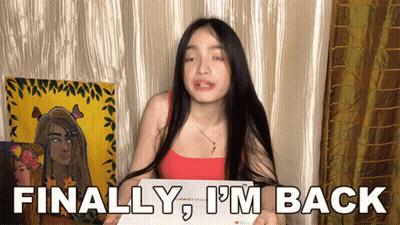 A Woman Holding A Piece Of Paper With The Words Finally I 'M Back On It GIF