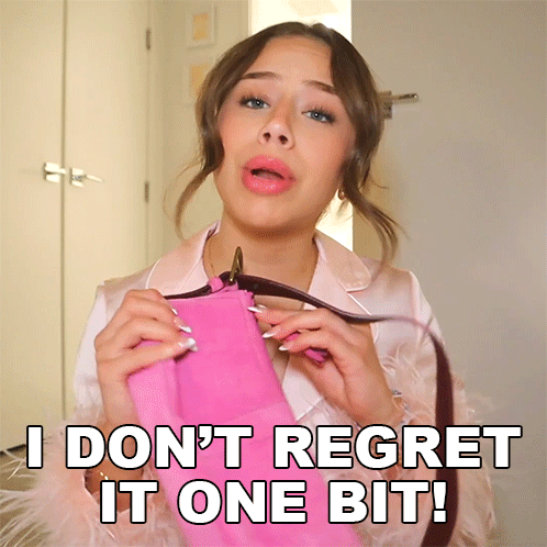 A Woman Holding A Pink Purse With The Words " I Don 'T Regret It One Bit " Above Her GIF