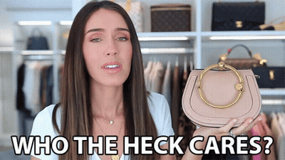 A Woman Holding A Purse With The Words Who The Heck Cares GIF