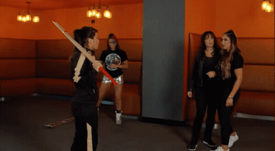 A Woman Holding A Sword With The Words " Shida Later " On The Bottom GIF