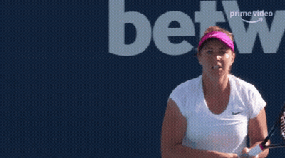 A Woman Holding A Tennis Racquet In Front Of A Betting Logo GIF