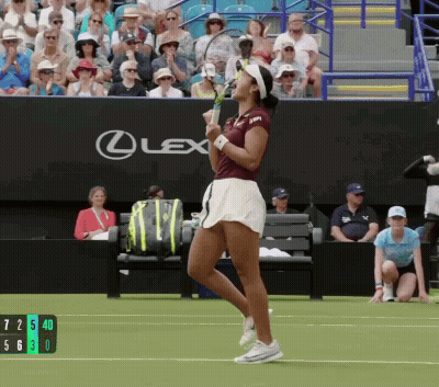 A Woman Holding A Tennis Racquet In Front Of A Lexus Banner GIF