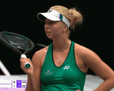 A Woman Holding A Tennis Racquet In Front Of A Scoreboard That Says Ad GIF