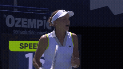A Woman Holding A Tennis Racquet In Front Of A Scoreboard That Says Spee GIF