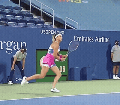 A Woman Holding A Tennis Racquet On A Tennis Court In Front Of A Emirates Airline Sign GIF