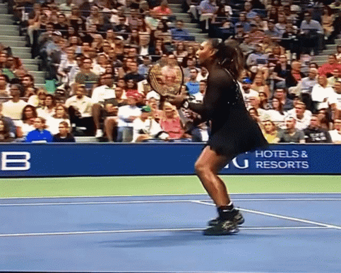 A Woman Holding A Tennis Racquet On A Tennis Court In Front Of A Hotel And Resorts Sign GIF