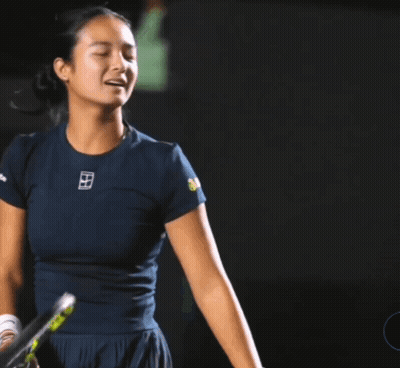 a woman holding a tennis racquet with a shirt that says ' nike ' on it