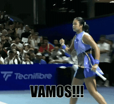 a woman holding a tennis racquet with vamos written on the bottom