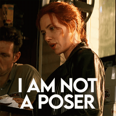 A Woman Holding A Tray With The Words " I Am Not A Poser " Written On It GIF