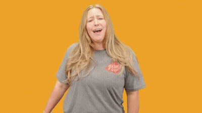 A Woman Holding A Unicorn Sticker With The Words You 'Re A Unicorn GIF