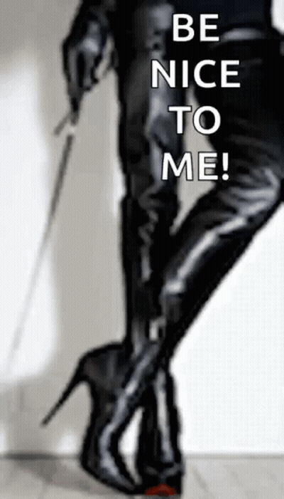 A Woman Holding A Whip With The Words Be Nice To Me Written On The Bottom GIF