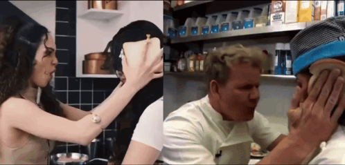 A Woman Holds A Piece Of Bread Over A Man 'S Face In A Kitchen GIF