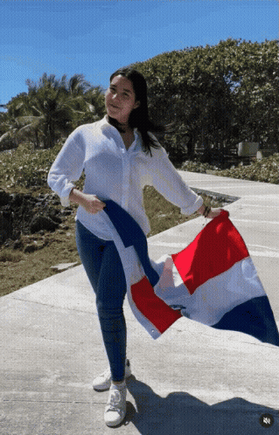 A Woman Holds A Red White And Blue Flag In Her Hand GIF