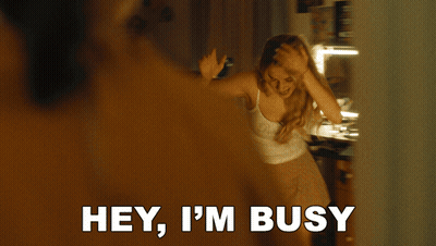 A Woman Holds Her Hand To Her Forehead And Says I 'M Busy GIF
