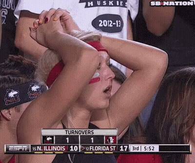 A Woman Holds Her Head While Watching A Game Between The Huskies And The Florida St. GIF