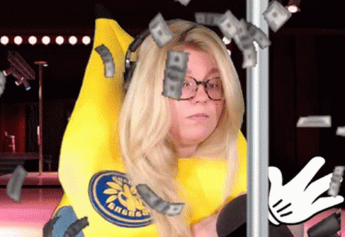 A Woman In A Banana Costume Has Money Falling Around Her Head GIF