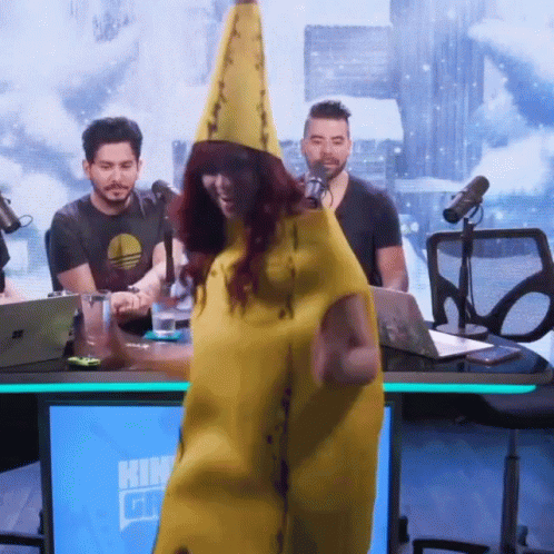 A Woman In A Banana Costume Stands In Front Of A Blue Screen That Says ' Kin ' GIF