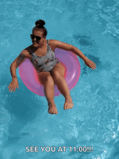 A Woman In A Bathing Suit Is Floating In A Swimming Pool With The Words See You At 11:00 Below Her GIF