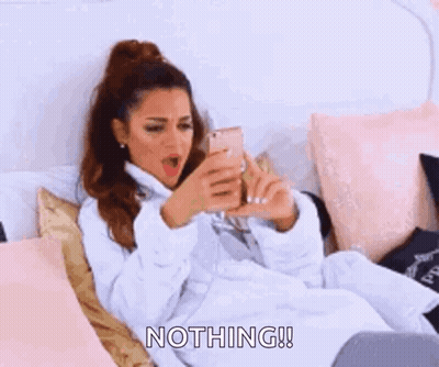 A Woman In A Bathrobe Is Laying On A Bed And Saying Nothing ! GIF