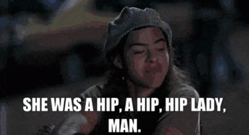 A Woman In A Beanie Is Smoking A Cigarette And Says She Was A Hip A Hip Hip Lady Man . GIF