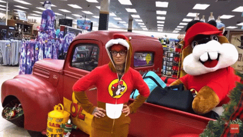 A Woman In A Beaver Costume Stands In Front Of A Red Truck With A Propane Tank In The Back GIF
