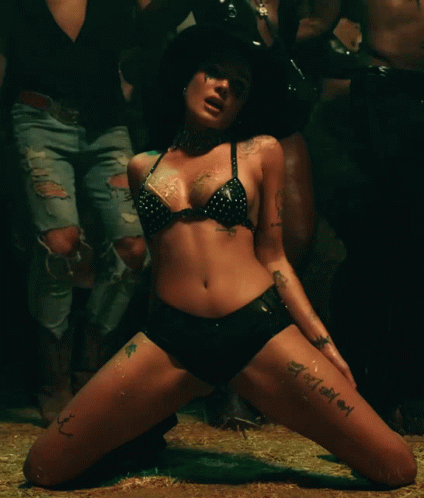 A Woman In A Bikini And Shorts Has A Tattoo On Her Leg That Says ' I Love You ' GIF