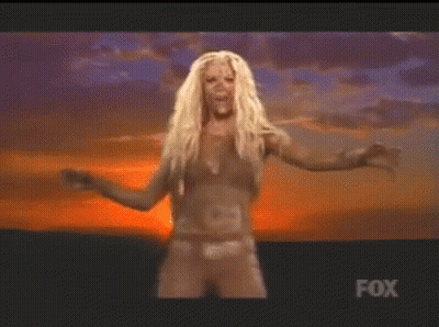 A Woman In A Bikini Is Dancing In Front Of A Fox Sign GIF