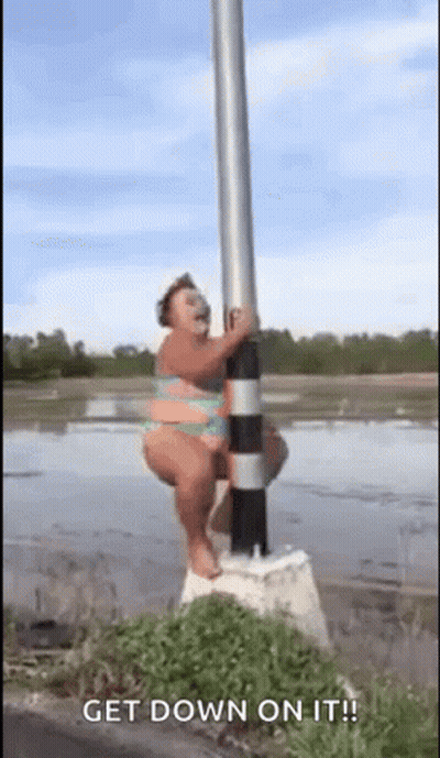 A Woman In A Bikini Is Hanging On A Pole . GIF