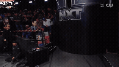 A Woman In A Bikini Is Holding A Chainsaw In A Ring GIF