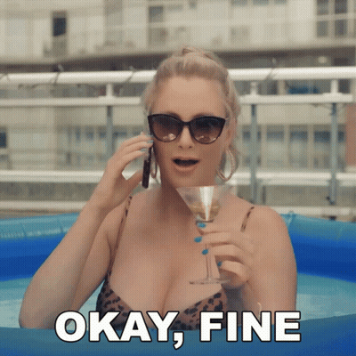 A Woman In A Bikini Is Holding A Martini And Talking On A Cell Phone With The Words " Okay Fine " Behind Her GIF