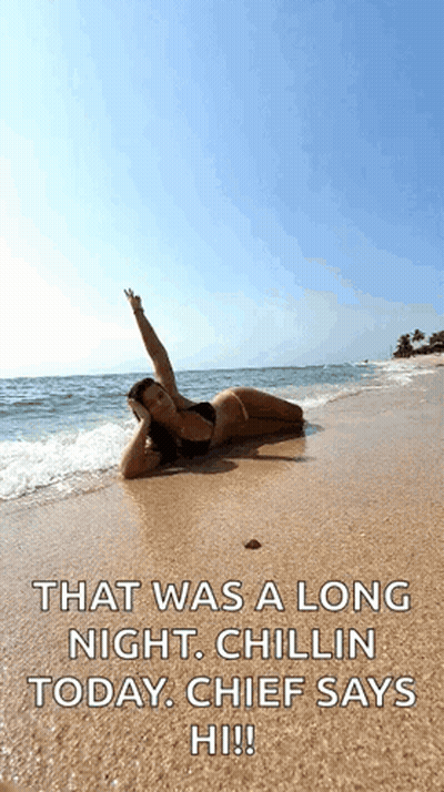 A Woman In A Bikini Is Laying On The Beach With The Words That Was A Long Night Chillin Today Chief Says Hi !! GIF