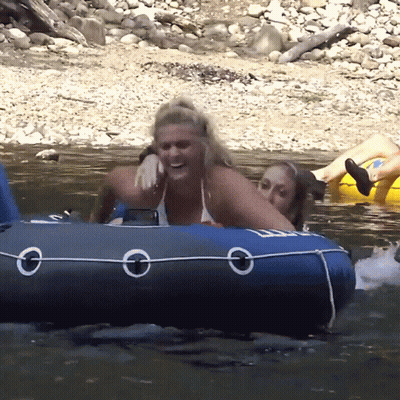 A Woman In A Bikini Sits On A Blue Raft With The Letter O On The Side GIF