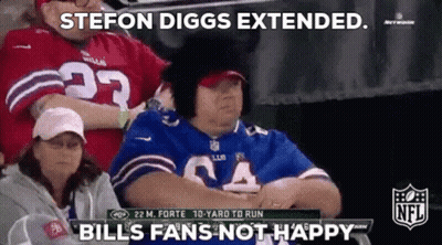 A Woman In A Bills Jersey Is Sitting In The Stands Watching A Football Game GIF
