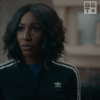 A Woman In A Black Adidas Jacket Is Asking Really GIF