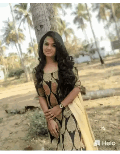 A Woman In A Black And Gold Dress Is Standing Next To A Tree Sticker