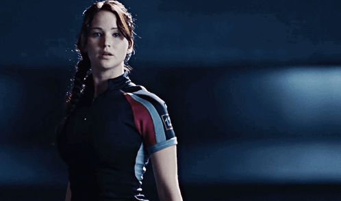 A Woman In A Black And Red Shirt With The Letter A On It GIF