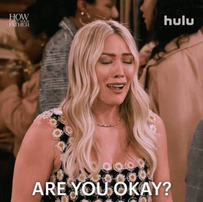 A Woman In A Black And White Dress Is Asking If She Is Okay GIF
