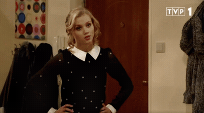 A Woman In A Black And White Polka Dot Dress Is Standing In Front Of A Tvp 1 Logo GIF