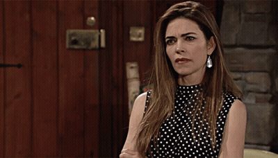 A Woman In A Black And White Polka Dot Top Is Making A Face GIF