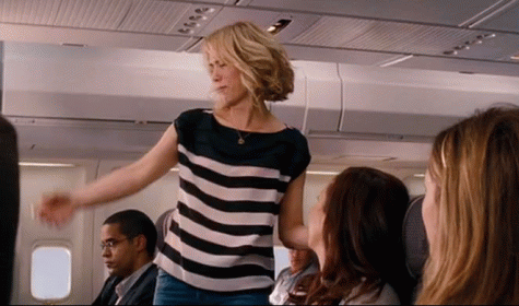A Woman In A Black And White Striped Shirt Is Dancing On A Plane GIF