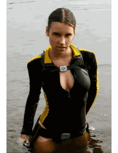 A Woman In A Black And Yellow Outfit Is Standing In A Body Of Water Sticker