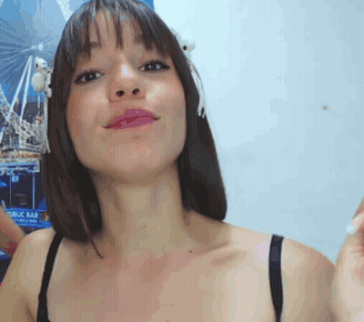 A Woman In A Black Bra Stands In Front Of A Ferris Wheel Poster GIF