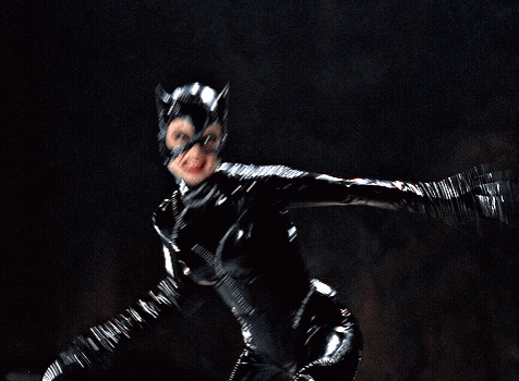 A Woman In A Black Catsuit Is Flying Through The Air GIF
