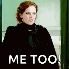 A Woman In A Black Coat Is Standing In A Doorway With The Words `` Me Too '' Written On Her Face . GIF