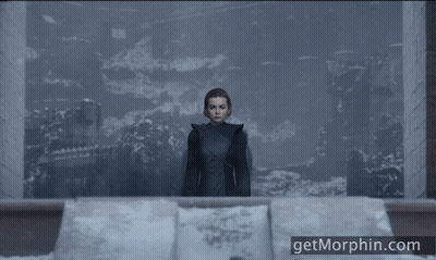 A Woman In A Black Coat Stands In Front Of A Wall With The Website Getmorphin.com Below Her GIF