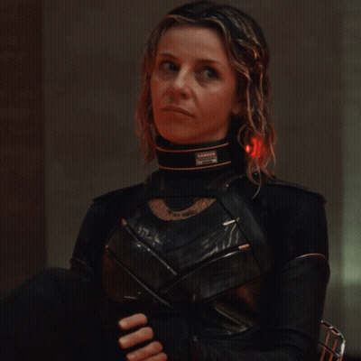A Woman In A Black Costume Has A Collar That Says ' Danger ' On It GIF